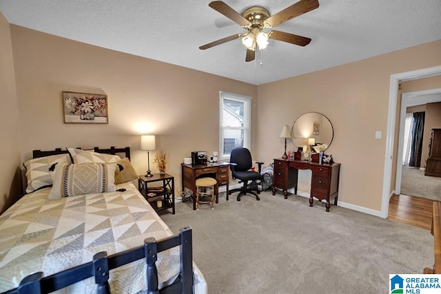 carpeted bedroom featuring a textured ceiling and ceiling fan