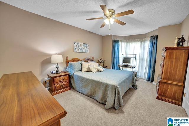 carpeted bedroom featuring a textured ceiling and ceiling fan