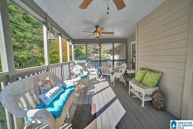 sunroom featuring ceiling fan