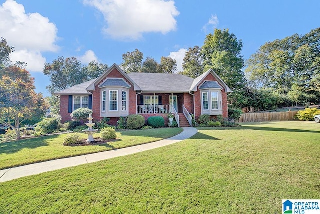 single story home featuring a front yard and covered porch