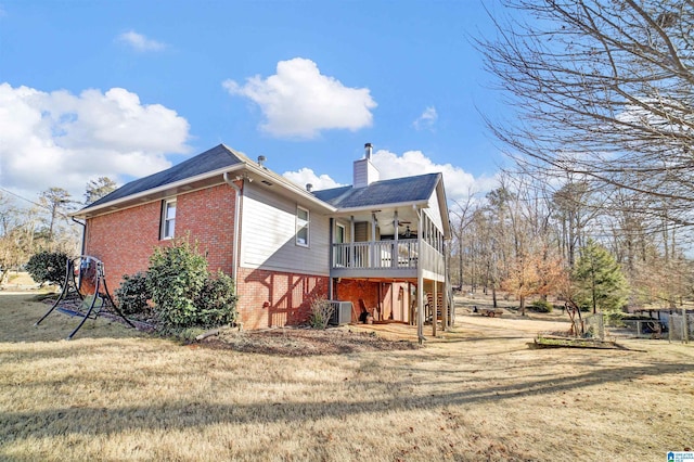 back of house featuring ceiling fan, a lawn, and central air condition unit