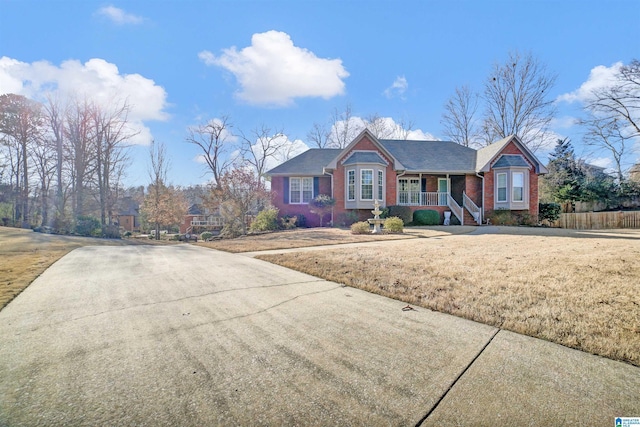 single story home featuring a front yard and covered porch