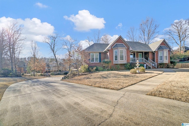 view of front of home with a porch and a front yard