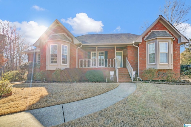 view of front of property with a porch and a front lawn