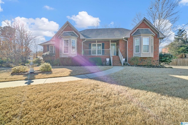 view of front of home with a front yard and a porch