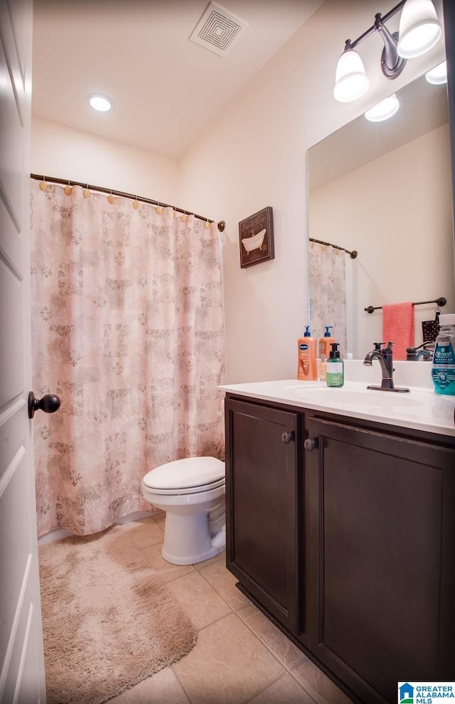 bathroom with vanity, toilet, curtained shower, and tile patterned flooring