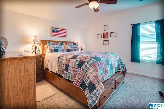 bedroom with light colored carpet, vaulted ceiling, and ceiling fan