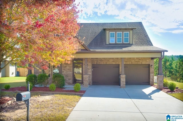 view of front of home with a front yard and a garage