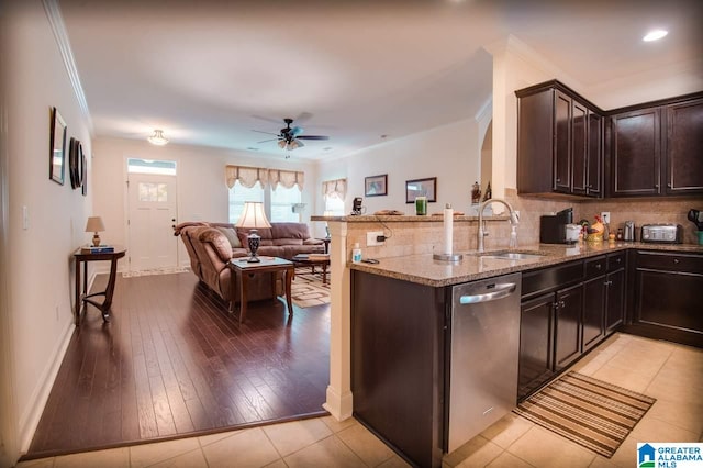 kitchen with dishwasher, sink, light stone countertops, light hardwood / wood-style floors, and ceiling fan