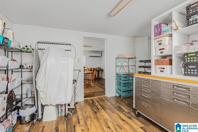 interior space with a wall mounted AC and dark hardwood / wood-style floors