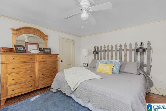 bedroom with ornamental molding, ceiling fan, and dark hardwood / wood-style flooring