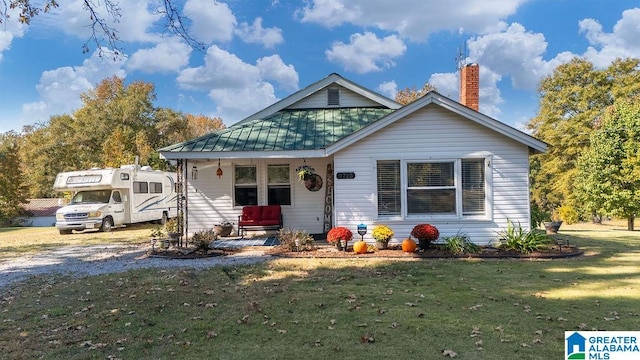 bungalow-style home with a front yard