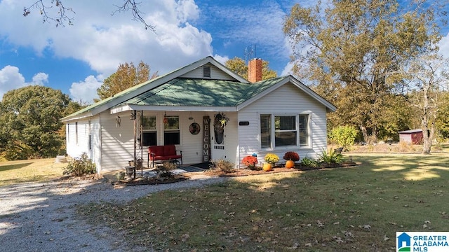 bungalow-style house featuring a shed, a front yard, and a porch