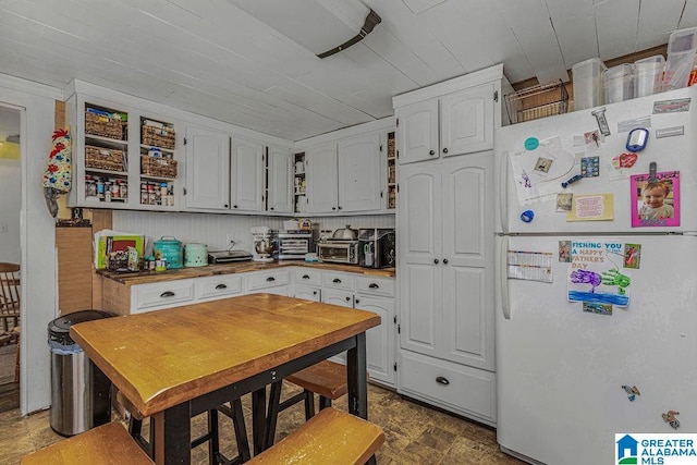 kitchen with white cabinetry and white refrigerator