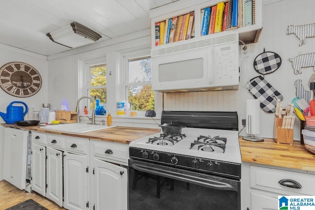 kitchen featuring white cabinetry, wood counters, light wood-type flooring, sink, and white appliances