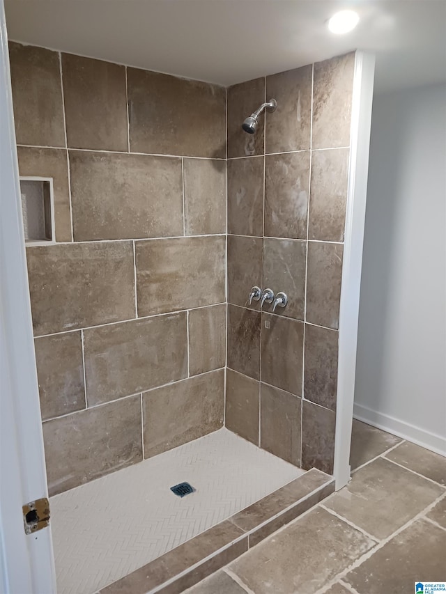 bathroom with a tile shower