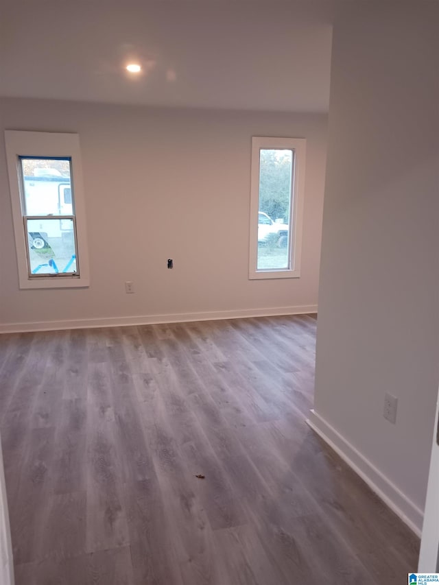 unfurnished room with a healthy amount of sunlight and wood-type flooring