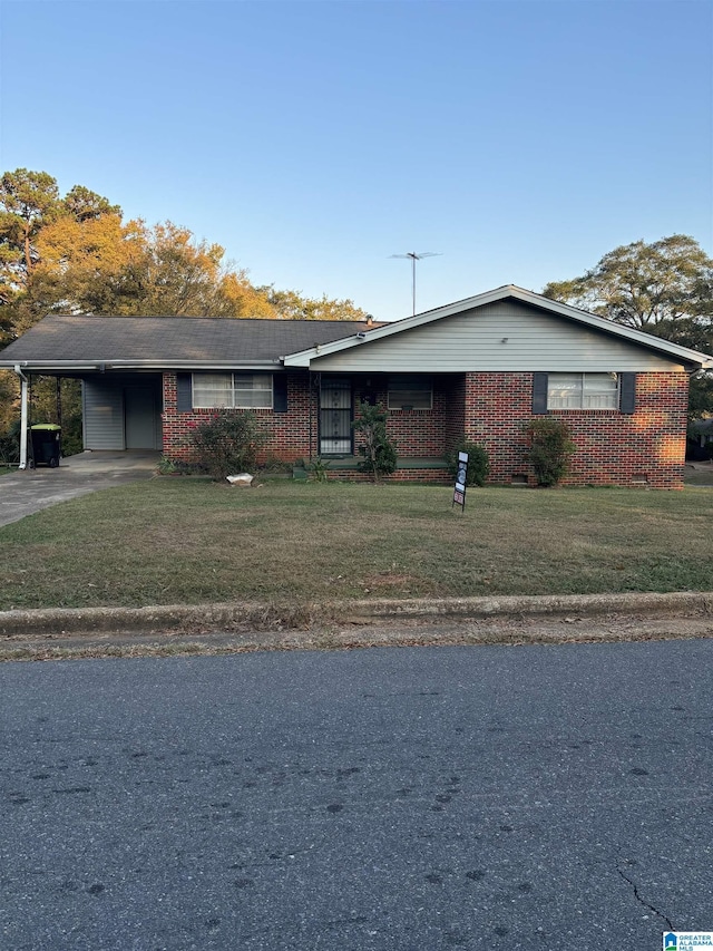 ranch-style house with brick siding, a front yard, concrete driveway, and an attached carport