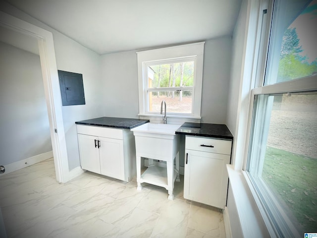 clothes washing area with electric panel