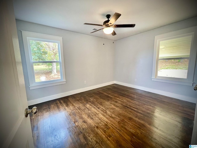 spare room with ceiling fan and dark hardwood / wood-style floors