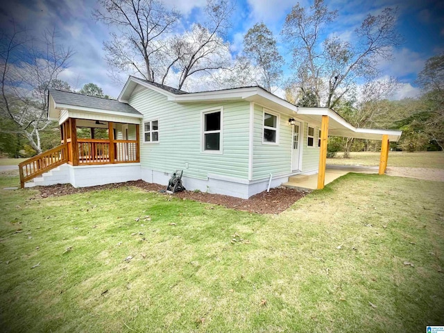 back of house with a yard and a patio area