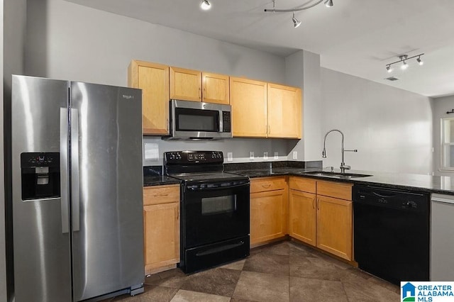 kitchen featuring kitchen peninsula, track lighting, black appliances, and sink