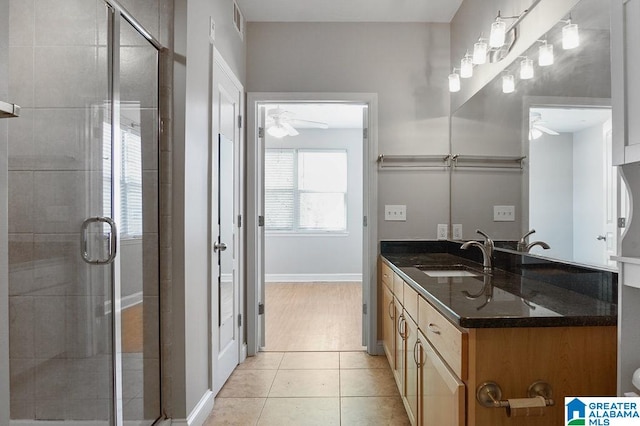 bathroom featuring vanity, ceiling fan, walk in shower, and tile patterned flooring