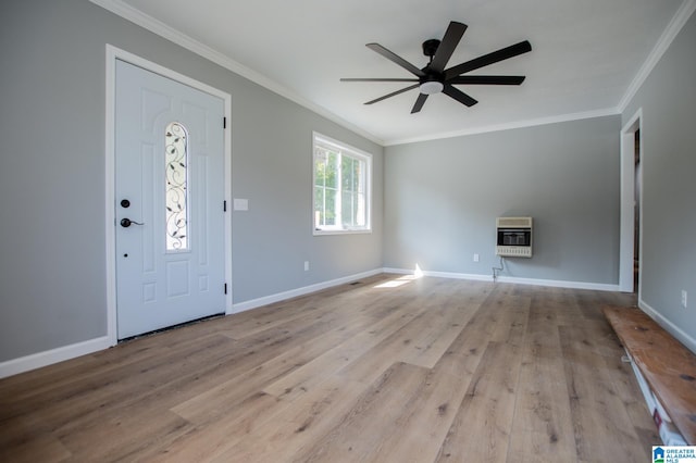 foyer entrance with light hardwood / wood-style floors, ornamental molding, heating unit, and ceiling fan