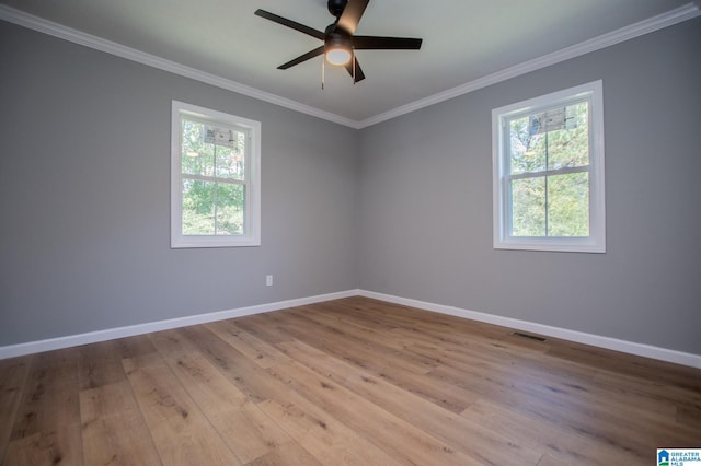 empty room with light hardwood / wood-style floors, ornamental molding, and ceiling fan