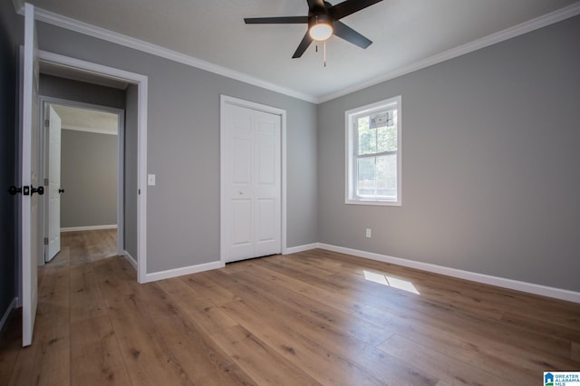 unfurnished bedroom featuring crown molding, light wood-type flooring, and ceiling fan