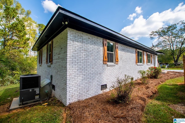 view of side of home featuring central AC unit