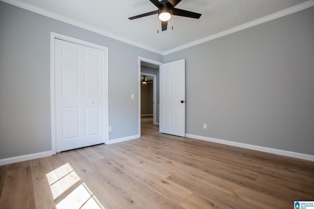 unfurnished bedroom with ornamental molding, light wood-type flooring, and ceiling fan