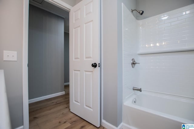 bathroom featuring wood-type flooring and shower / bathtub combination