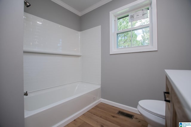 full bathroom with hardwood / wood-style floors, shower / tub combination, crown molding, and toilet