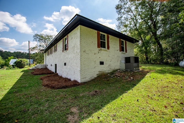 view of side of home with a yard