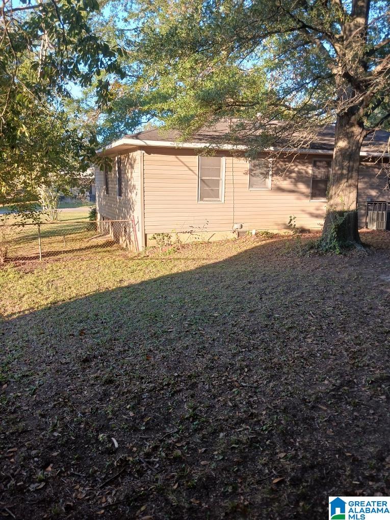 view of side of property with a lawn