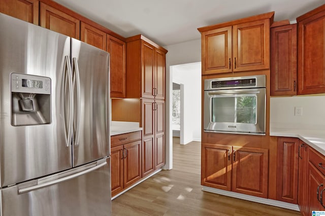 kitchen with stainless steel appliances and light wood-type flooring