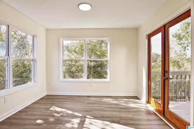 unfurnished sunroom featuring french doors