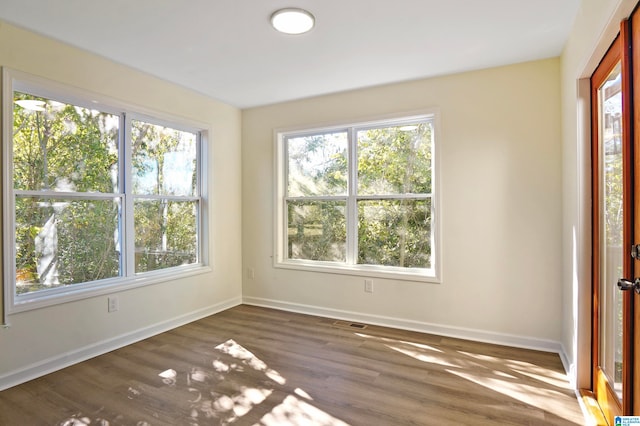 empty room with dark hardwood / wood-style floors