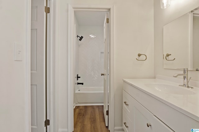 bathroom with vanity, hardwood / wood-style floors, and shower / tub combination