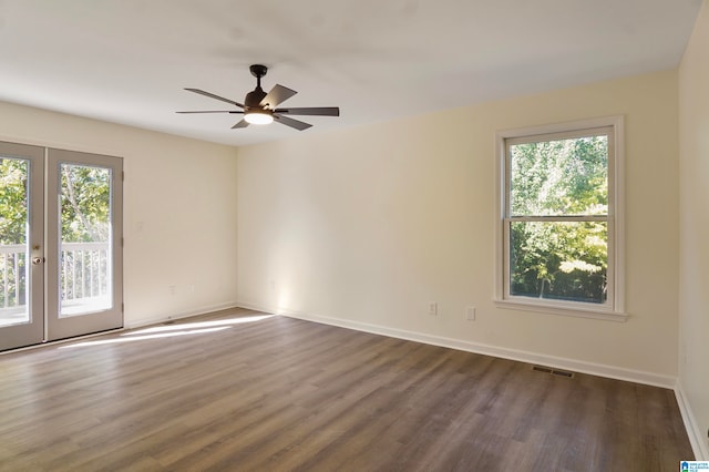 spare room featuring french doors, dark hardwood / wood-style floors, and ceiling fan