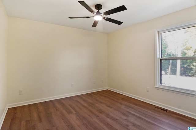 unfurnished room featuring ceiling fan and dark hardwood / wood-style flooring