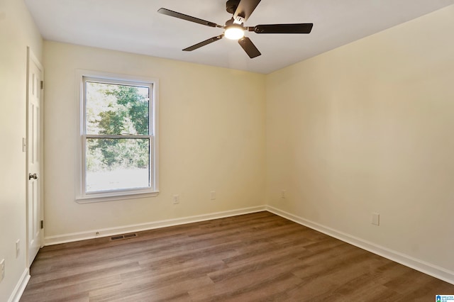 spare room featuring wood-type flooring and ceiling fan