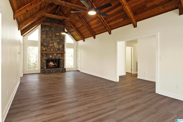 unfurnished living room featuring a fireplace, ceiling fan, beamed ceiling, wooden ceiling, and dark wood-type flooring