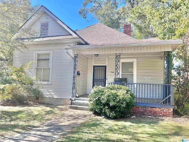 bungalow-style house with a front yard and a porch