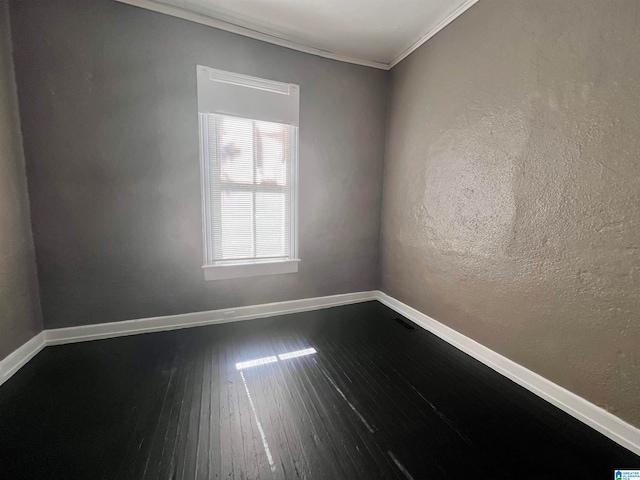 empty room featuring ornamental molding and wood-type flooring