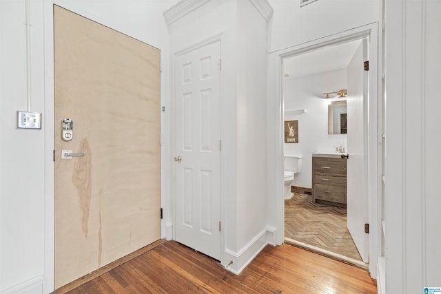 corridor with hardwood / wood-style flooring