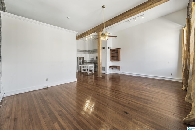 unfurnished living room featuring baseboards, lofted ceiling with beams, ceiling fan, and wood-type flooring