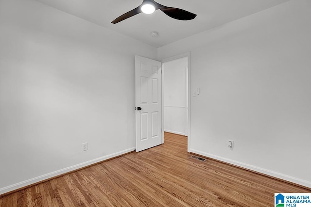 empty room with light hardwood / wood-style floors and ceiling fan