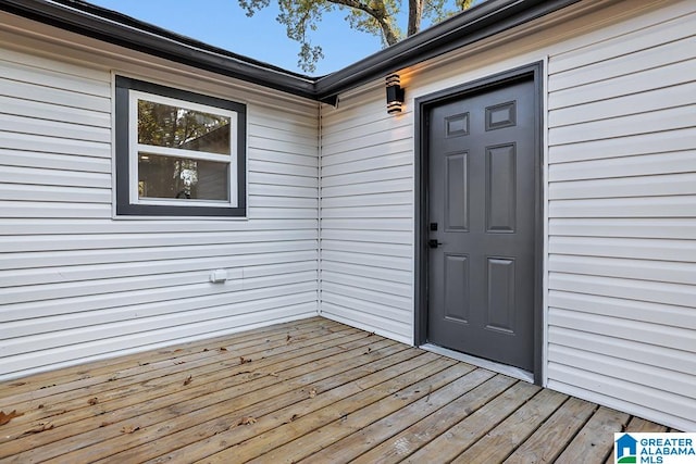 doorway to property featuring a wooden deck